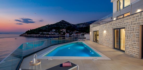 Beachfront Villa Frami with pool in sunset
